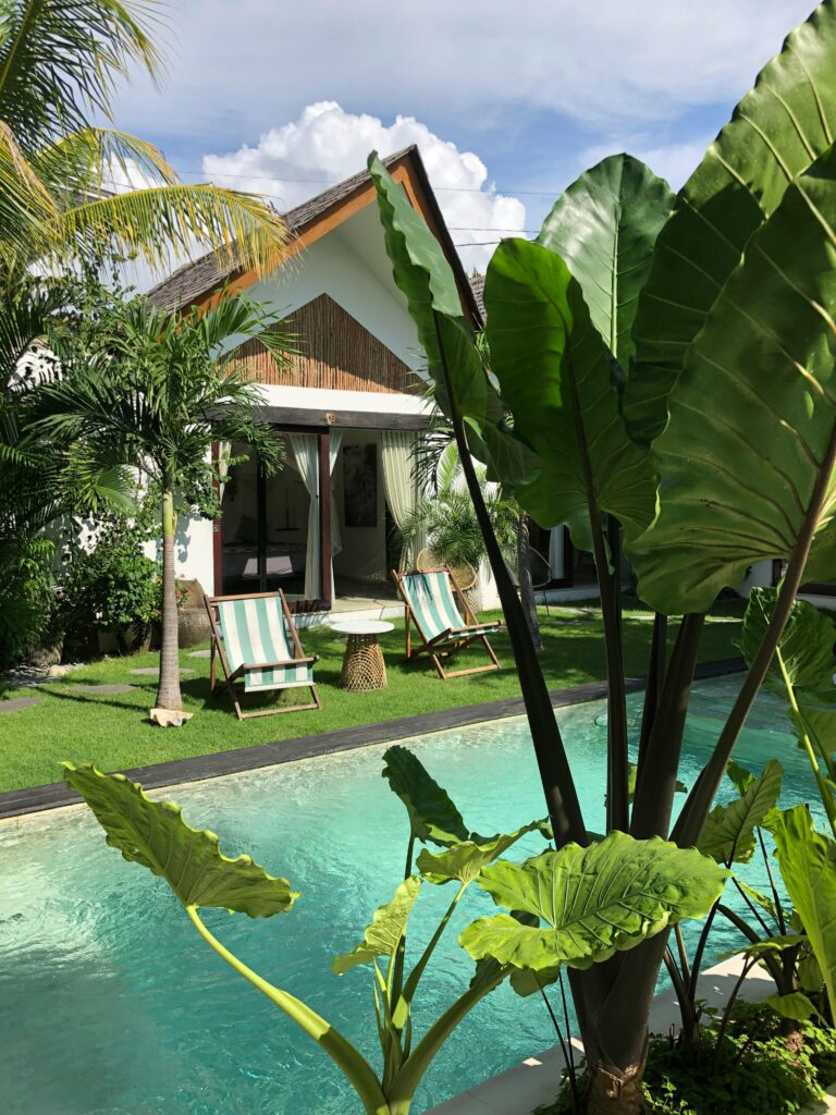 Luxurious villa in Bali with a private pool surrounded by tropical foliage.
